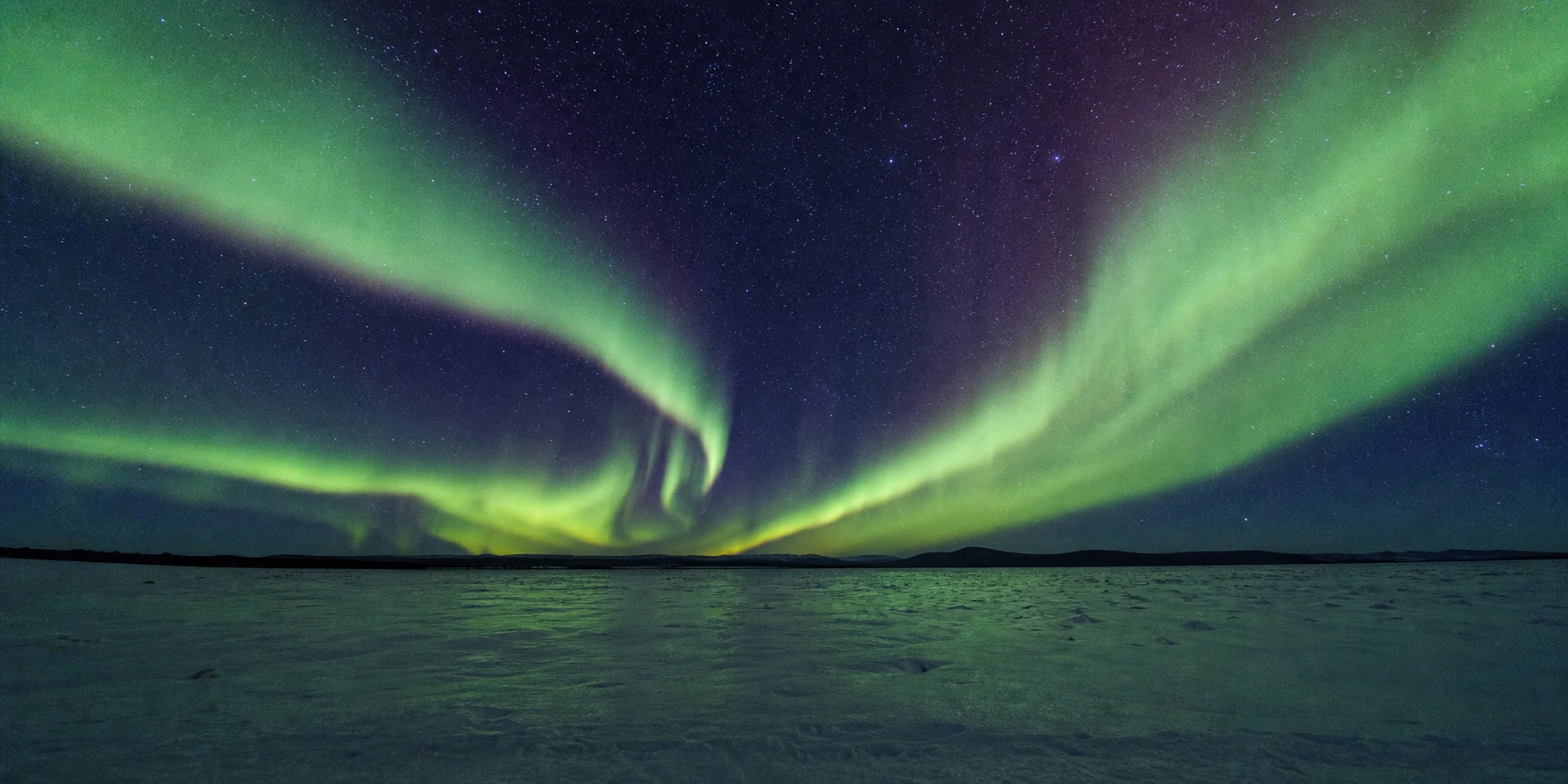Aurora ribbons branching across a polar night sky, depicting AI query reformulation splitting one query into many retrievals